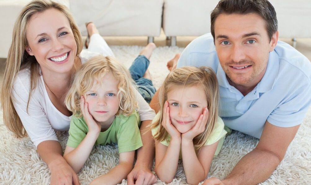 Family laying on their professionally cleaned carpet